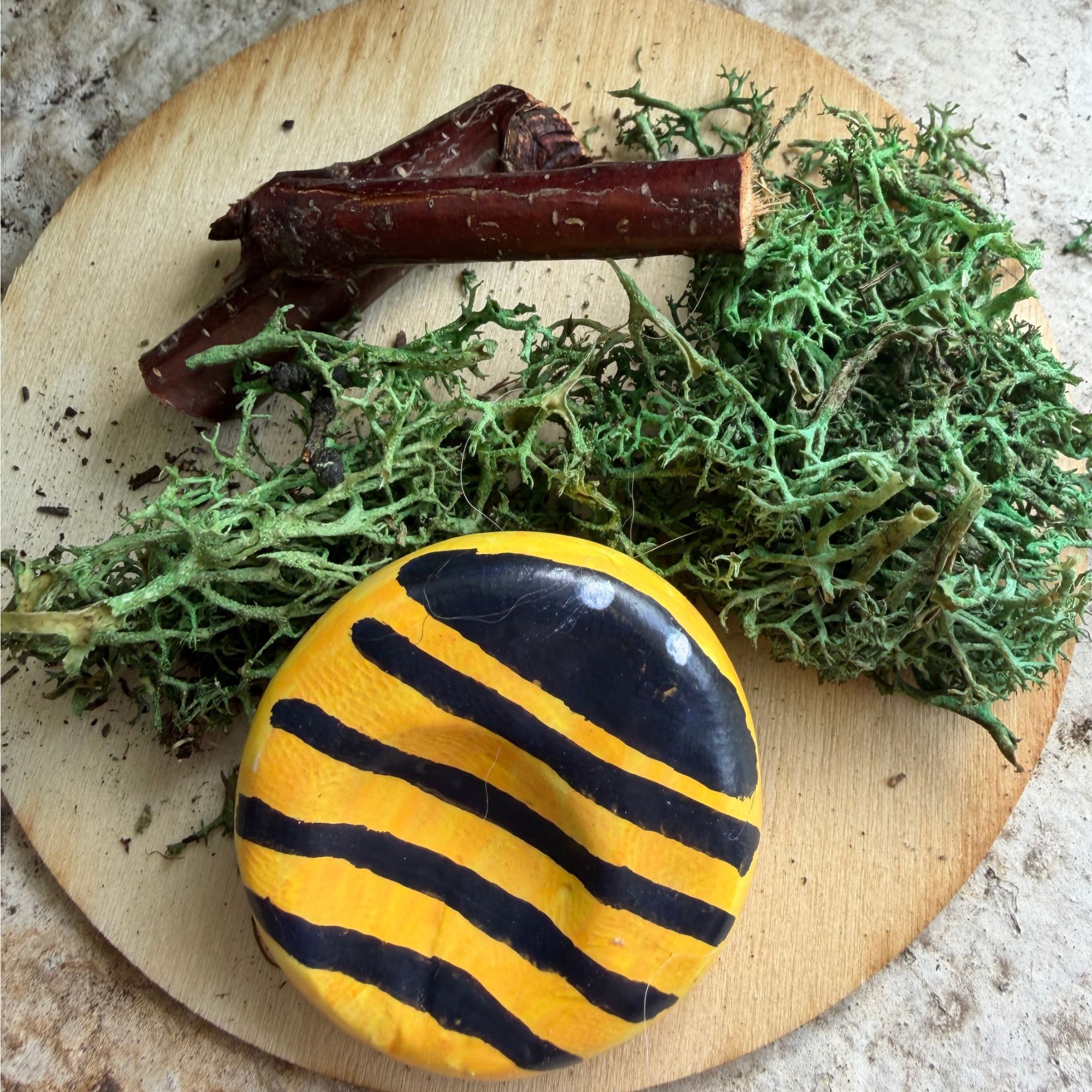 beeworrystonesands polymer clay worry stone painted to look like a bee. Yellow, with black stripes
