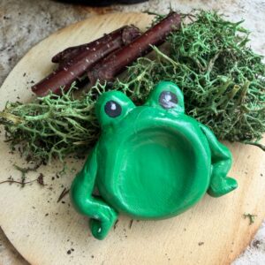 polymer clay worry stone in the shape of a green frog