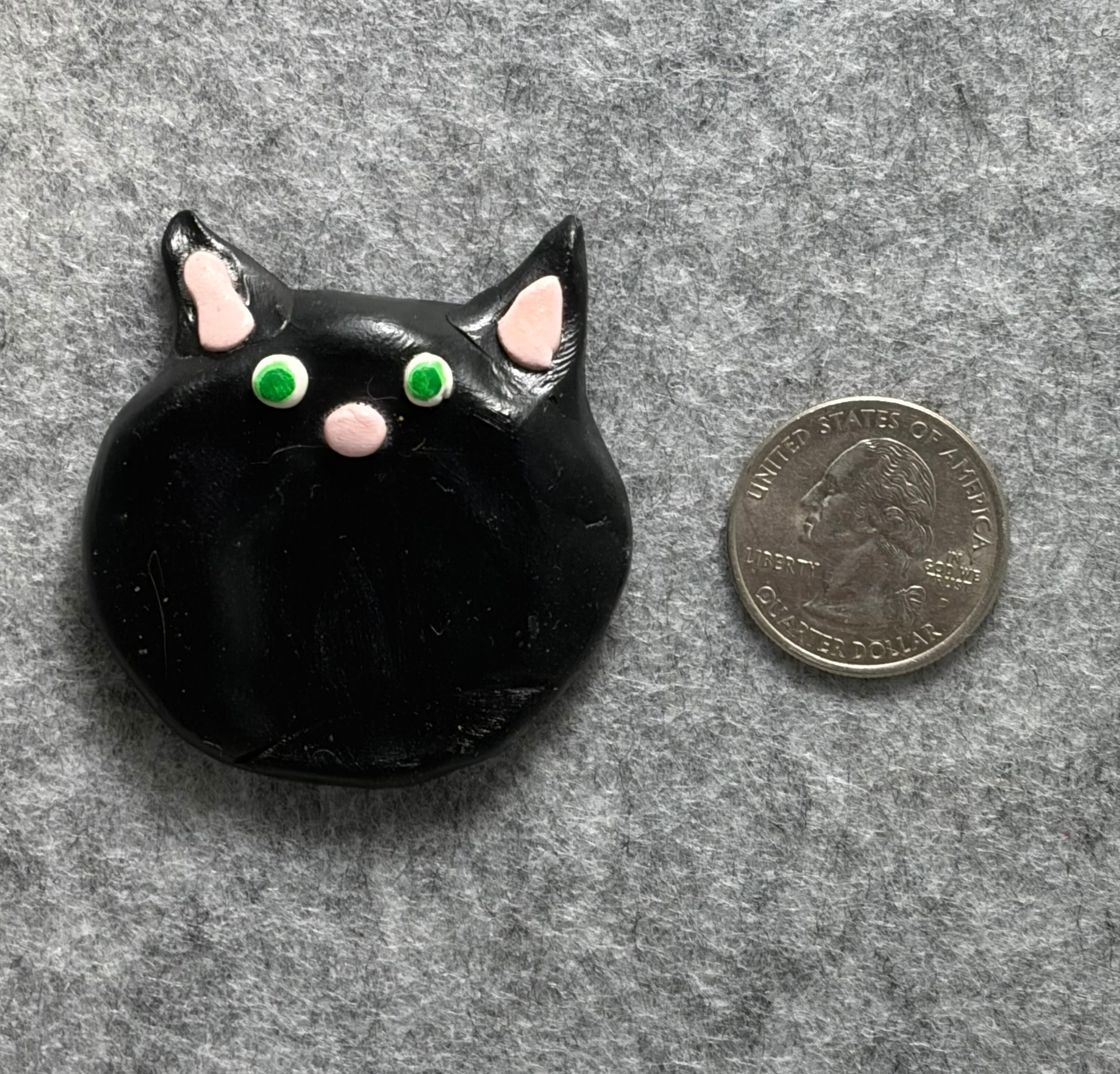 black cat worry stone 1 Black cat worry stone next to a US quarter for scale