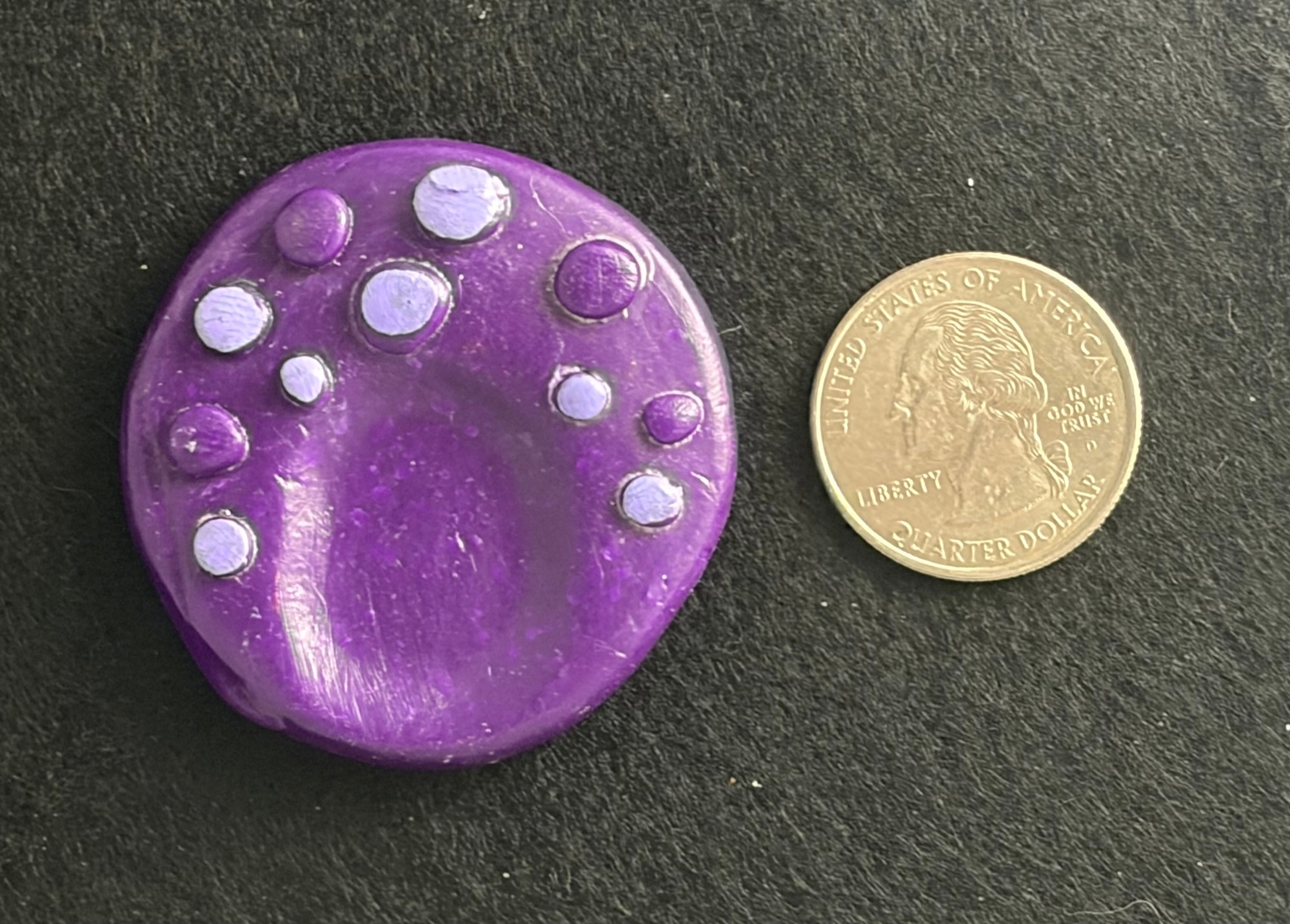 purple textured worry stone 2 Handmade purple textured polymer clay worry stone next to a US quarter for scale